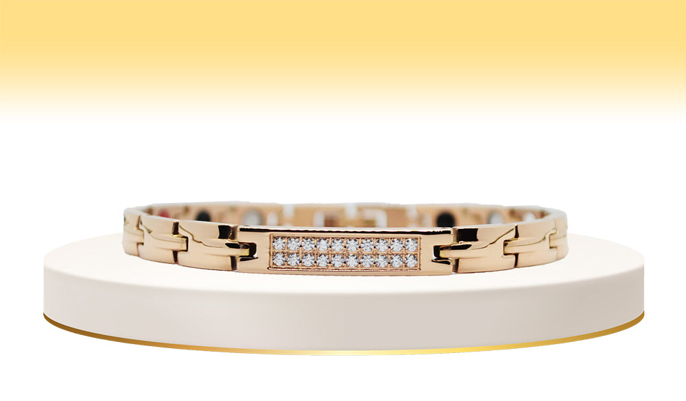 Main view of 'THE ABIGAIL' Women’s Rose Gold Double Bar Crystallized Bracelet, showcasing round brilliant cut crystals pave set in two beautiful rows on a bar top. The bronze bracelet exudes elegance, featuring ultra-shiny links along the wrist adorned with innovative technology for both style and well-being.