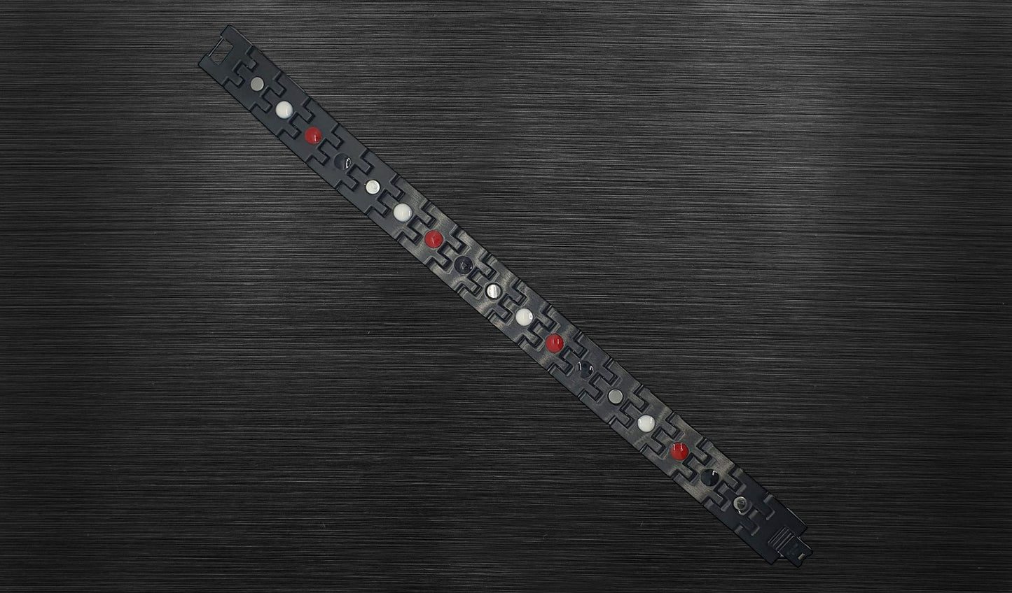 Turn to the back view of 'THE HENRY' to explore the durability and structure of each geometric gold-trimmed link. The durable hinges on each link contribute to the bracelet's handsome design, ensuring longevity and comfort. 'THE HENRY' is finished with a secure fold-over clasp, offering both style and security in every wear.