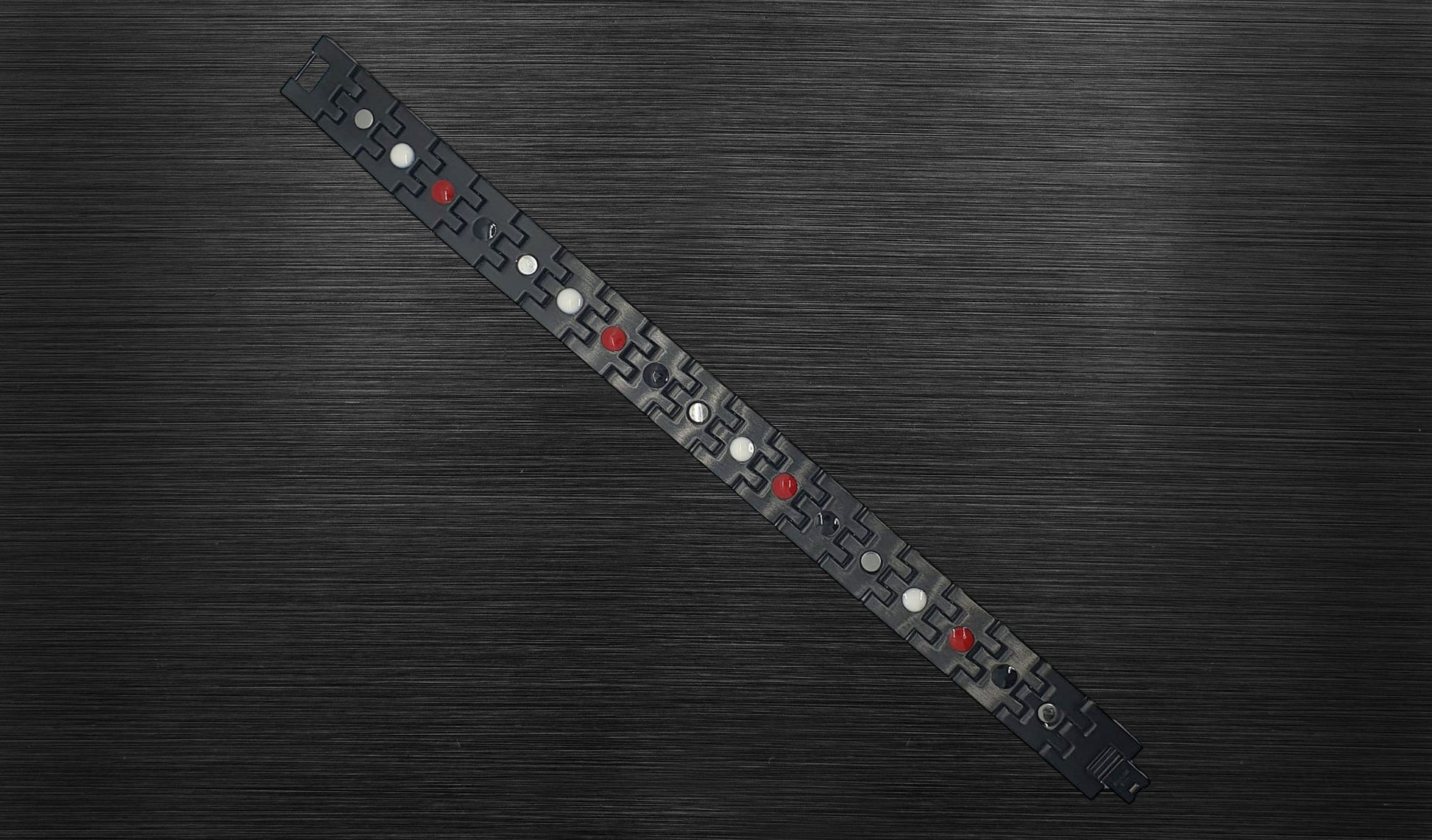 Turn to the back view of 'THE HENRY' to explore the durability and structure of each geometric gold-trimmed link. The durable hinges on each link contribute to the bracelet's handsome design, ensuring longevity and comfort. 'THE HENRY' is finished with a secure fold-over clasp, offering both style and security in every wear.