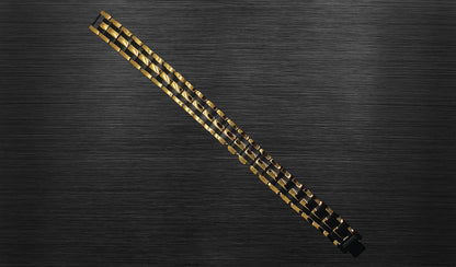 The front view of 'THE AUSTIN' allows you to appreciate the intricate details of its design. The combination of rich gold and durable black track links creates a visually captivating contrast, highlighting the bracelet's contemporary and sophisticated appeal. This view emphasizes the bold aesthetic that 'THE AUSTIN' brings to your wrist, making it a statement piece for various occasions.
