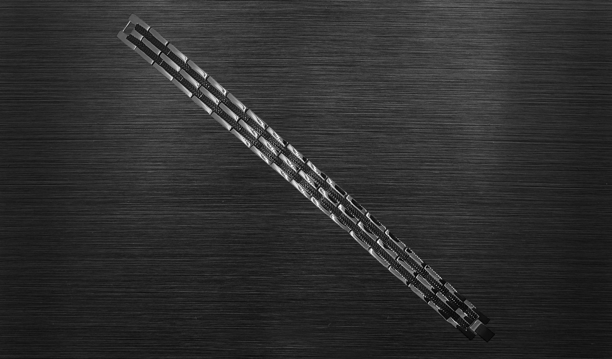 Front view of 'THE RYAN' Men's Silver/Black Double Trim Bracelet, highlighting the intricate details of the shiny silver trim and the captivating midnight black watch pattern. This perspective emphasizes the bracelet's modern luxury and the thoughtful combination of style and well-being.