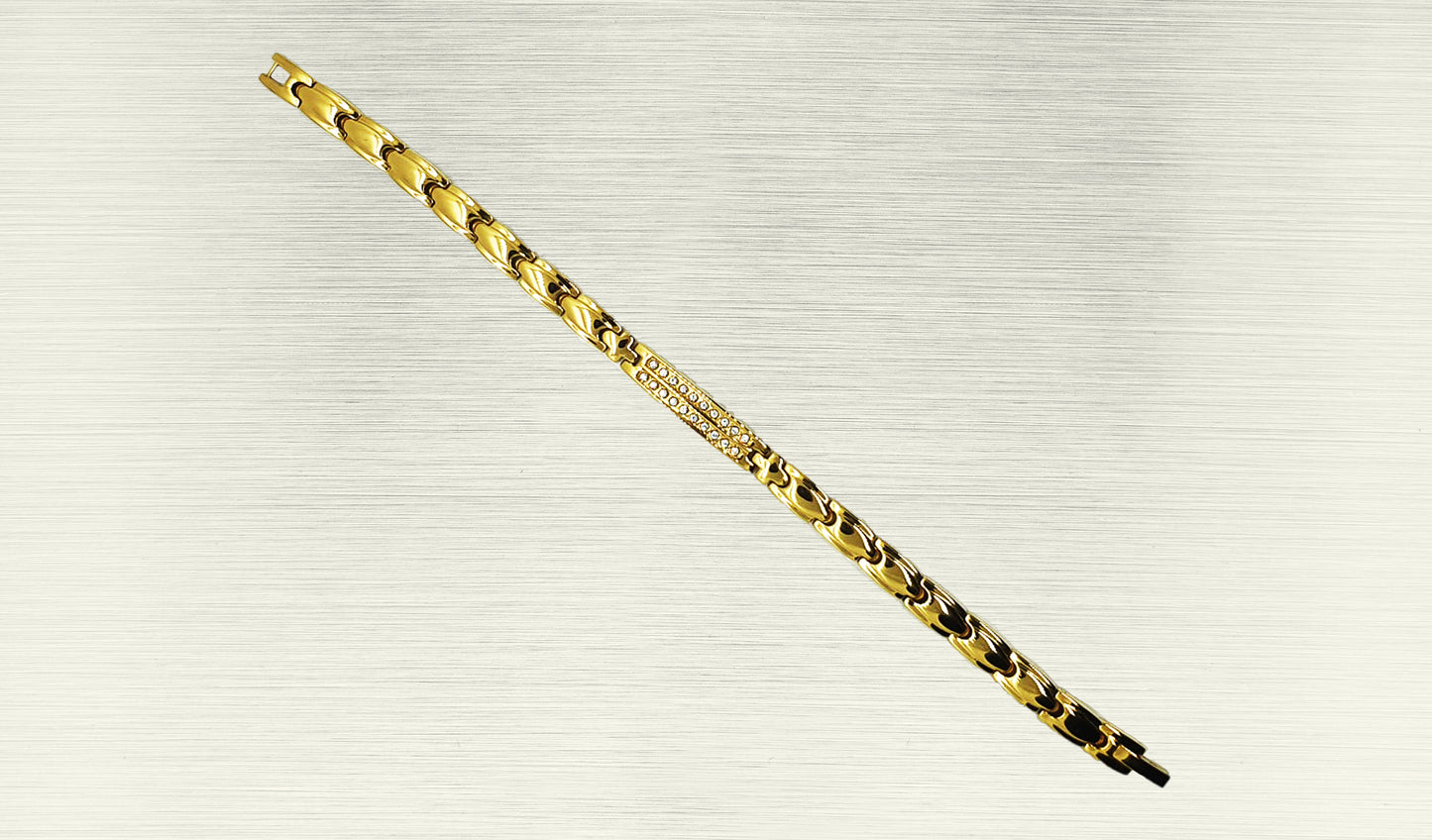 Front view of 'THE ANGELA' Women’s Gold Double Bar Crystallized Bracelet, highlighting the intricate details of the double bar design adorned with sparkling crystals. The gold links, polished to perfection, contribute to the bracelet's glamorous appeal. This view emphasizes the beauty and sophistication that make 'THE ANGELA' a standout accessory for women.