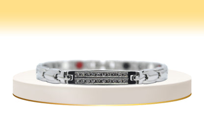 Main view of 'THE IRIS' Women’s Silver Double Bar Crystallized Bracelet, showcasing round brilliant cut crystals pave set in two beautiful rows on a bar top. This silver bracelet exudes elegance, featuring ultra-shiny links along the wrist adorned with innovative technology for both style and well-being.