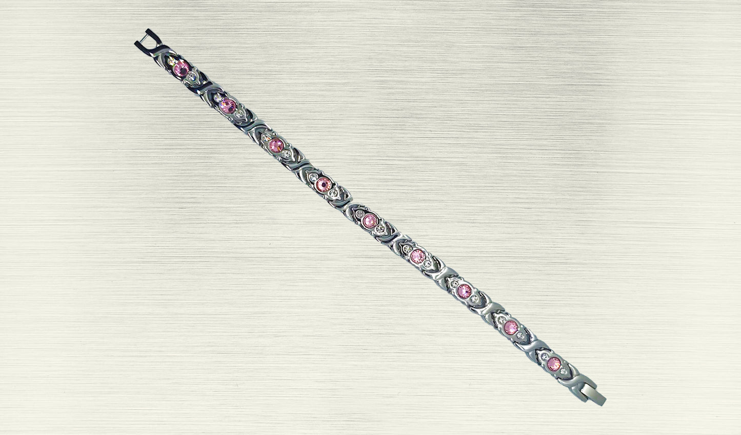 Front view of 'THE SOPHIA' Women’s Silver Pink Crystallized Filigree Bracelet, highlighting the intricate details of the filigree links adorned with sparkling pink crystals. The polished silver links add a radiant glow, enhancing the overall allure of this romantic design. This view emphasizes the captivating beauty that makes 'THE SOPHIA' a distinctive and chic addition to your jewelry collection.