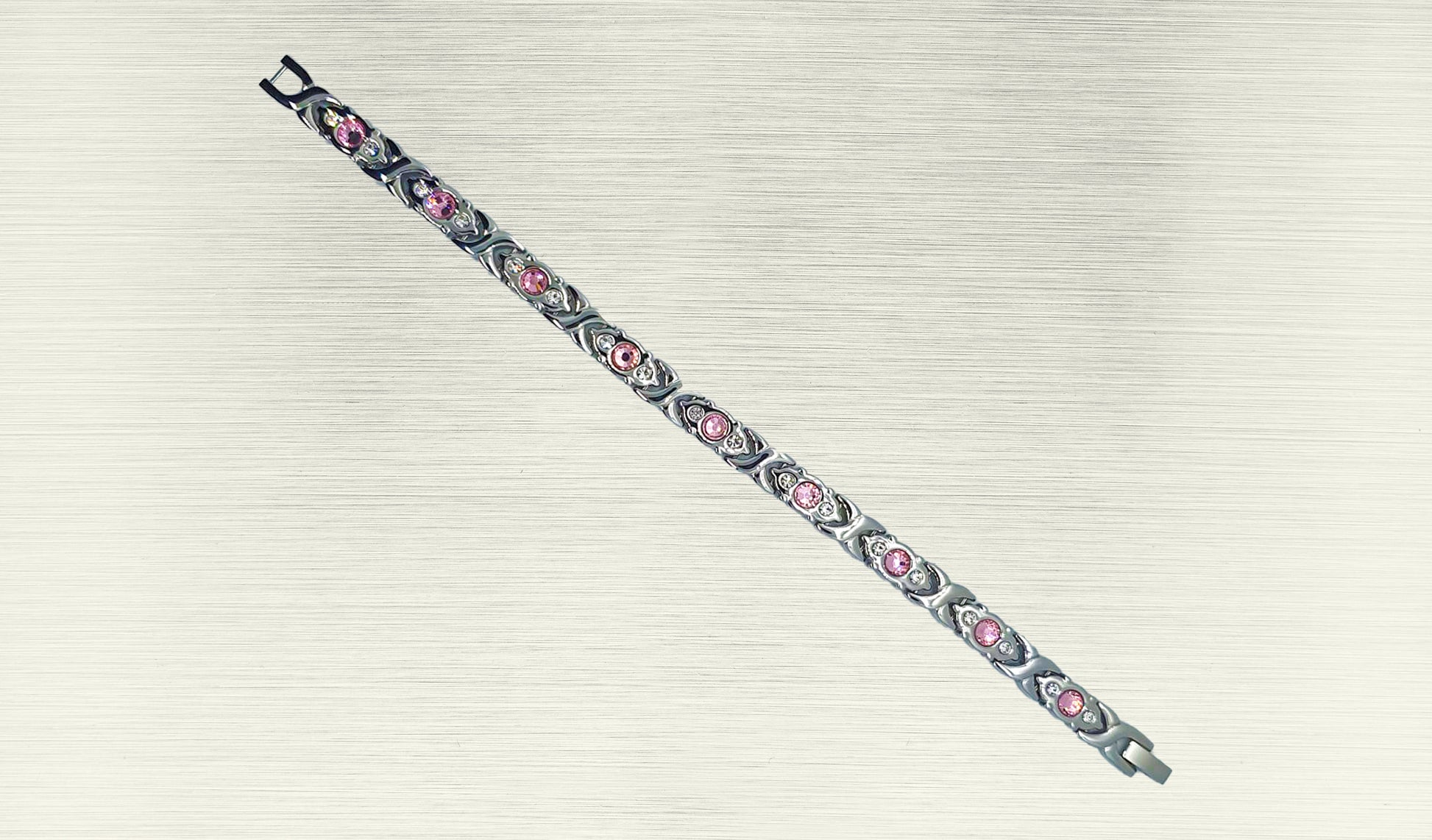 Front view of 'THE SOPHIA' Women’s Silver Pink Crystallized Filigree Bracelet, highlighting the intricate details of the filigree links adorned with sparkling pink crystals. The polished silver links add a radiant glow, enhancing the overall allure of this romantic design. This view emphasizes the captivating beauty that makes 'THE SOPHIA' a distinctive and chic addition to your jewelry collection.